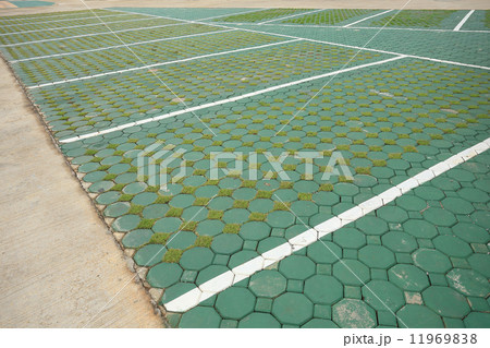 Empty space in car parking lot made from brick block and green g 11969838