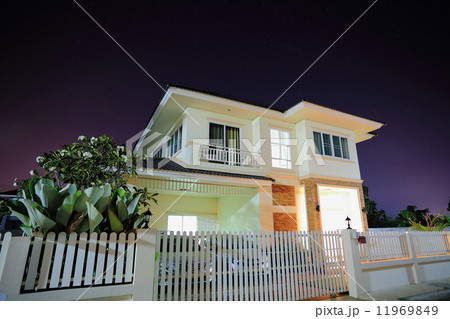 Big house open light in suburbs at night 11969849