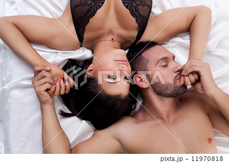 Top view of loving young couple in bed Top view of loving young couple in bed 11970818