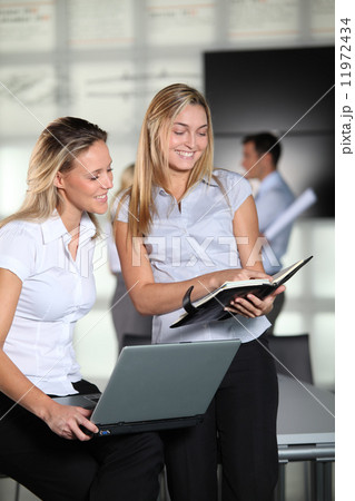 Smiling businesswomen in the office Smiling businesswomen in the office 11972434