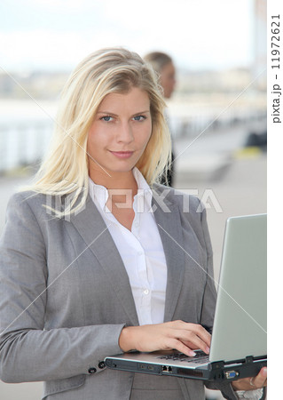 Closeup of businesswoman attending exhibition 11972621