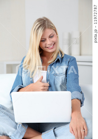 Blond woman at home connected on internet 11972787