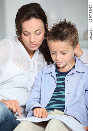 Mother helping son with homework Mother helping son with homework 11973644