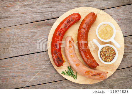 Various grilled sausages with condiments 11974823