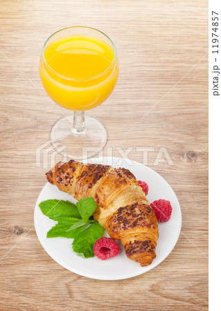 Orange juice and fresh croissant 11974857