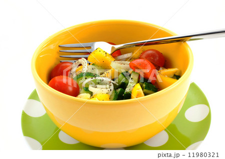 vegetable salad in a yellow bowl and fork 11980321