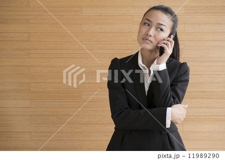 Asian Business Woman indoor with mobile telephone Asian Business Woman indoor with mobile telephone 11989290