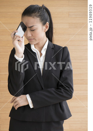 Asian Business Woman Indoor with mobile telephone Asian Business Woman Indoor with mobile telephone 11989319