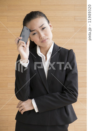 Asian Business Woman Indoor with mobile telephone 11989320