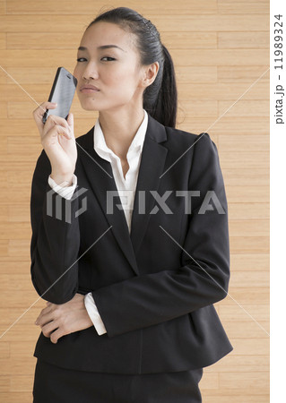 Asian Business Woman Indoor with mobile telephone 11989324