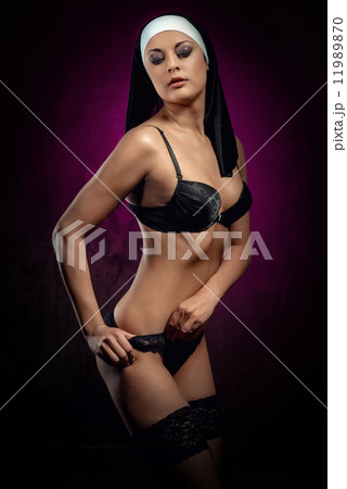 Sexy young nun posing indoors 11989870