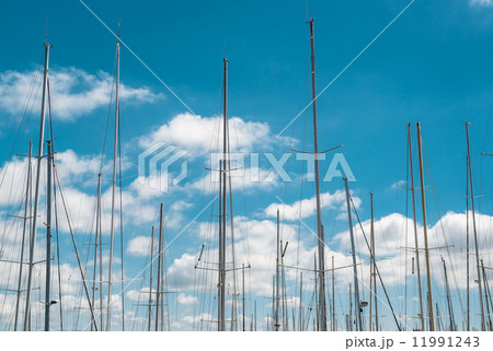 Ship masts over blue sky background 11991243