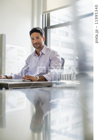 Office life. A man sitting at his desk. 11995340