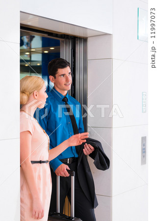 Couple waiting for hotel elevator or lift Couple waiting for hotel elevator or lift 11997073