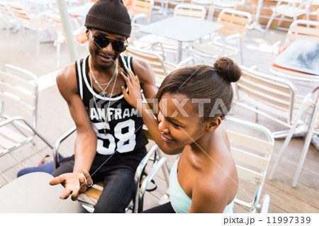 African couple having fun in cafe African couple having fun in cafe 11997339