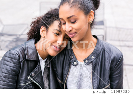 Best friends talking and having fun in park Best friends talking and having fun in park 11997389
