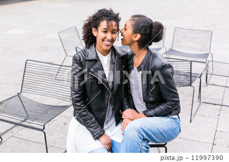 Best friends talking and having fun in park Best friends talking and having fun in park 11997390