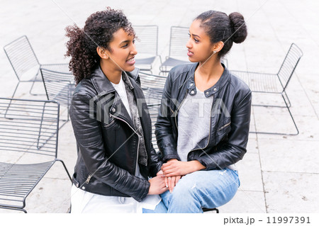 Best friends talking and having fun in park Best friends talking and having fun in park 11997391