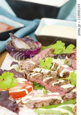 Grilled Beef Wraps - Griddled sirloin steak, sliced and served on a flatbread. 11998144