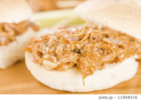 Pulled Pork Sliders - Juicy slow roasted pork meat in a white buns. 11998416