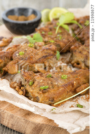Mutton Chaap - Fried battered spicy lamb cutlets garnished with green chilies and coriander. 11998677