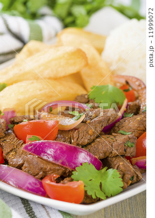 Lomo Saltado - Traditional Peruvian stir-fry with beef, red onions, tomatoes and fries Lomo Saltado - Traditional Peruvian stir-fry with beef, red onions, tomatoes and fries 11999072