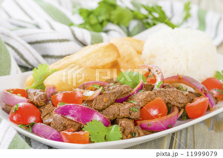 Lomo Saltado - Traditional Peruvian stir-fry with beef, red onions, tomatoes and fries Lomo Saltado - Traditional Peruvian stir-fry with beef, red onions, tomatoes and fries 11999079