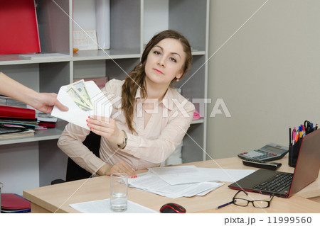 Business woman takes a bribe in an envelope 11999560