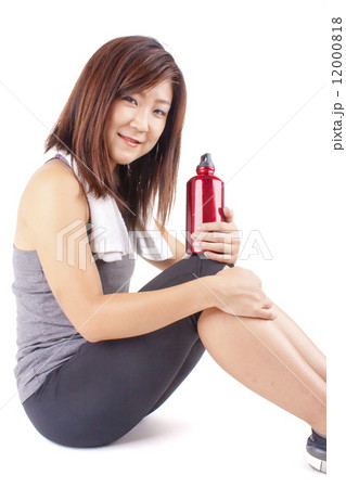 Young and fit pretty girl in exercise outfit holding red water bottle Young and fit pretty girl in exercise outfit holding red water bottle 12000818