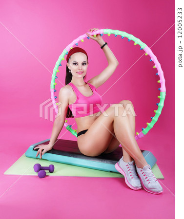 Healthy Lifestyle. Sporty Woman Sitting on Mat with Fitness Equipment 12005233