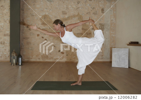 Woman doing yoga exercise 12006282