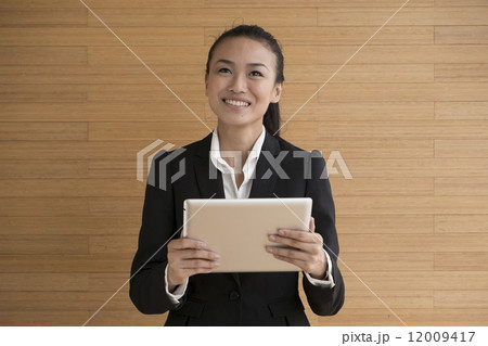 Asian Business Woman indoor with tablet Asian Business Woman indoor with tablet 12009417