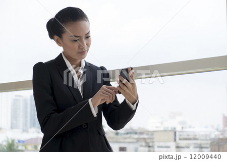 Asian Woman with mobile telephone 12009440