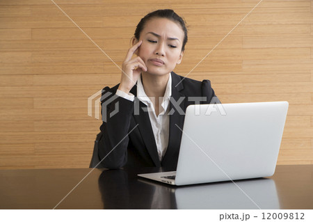 Asian Business Woman indoor with laptop computer 12009812