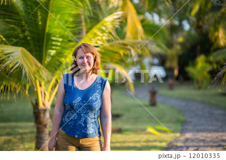 Smiling girl on a tropical beach resort on Bali Smiling girl on a tropical beach resort on Bali 12010335