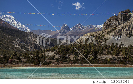 Prayer flags over mountain lake in Annapurna Circuit trail, Nepa 12012245