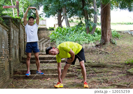 Men Stretching in the Park 12015259