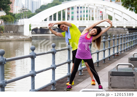 Man & Woman Stretching in the City 12015389