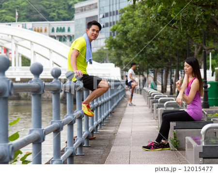 Man & Woman Relaxing After Exercise in the City Man & Woman Relaxing After Exercise in the City 12015477