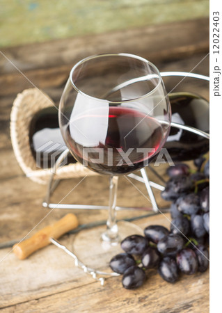 Winery menu background. Red wine with cluster od ripe fresh blue grapes 12022403