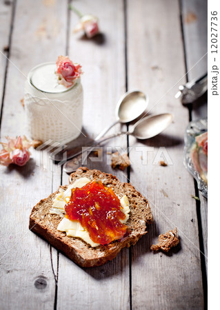Piece of bread with butter, jam and  yogurt Piece of bread with butter, jam and  yogurt 12027736