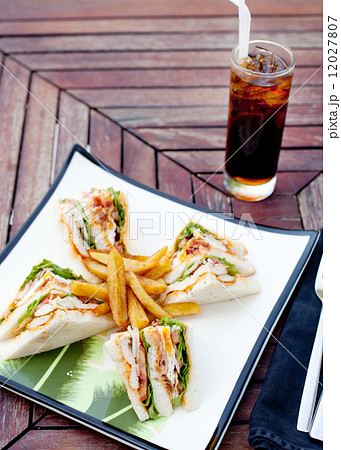Club sandwich with iced soda drink 12027807