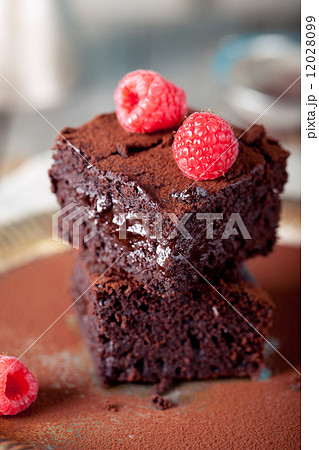 Brownies with raspberry on a wooden background. 12028099