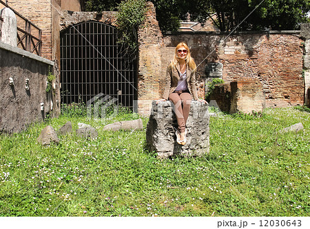 Attractive girl near the picturesque ruins of Rome, Italy 12030643