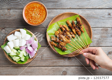People eating satay 12037577