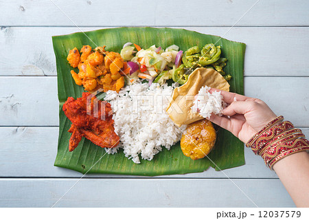 Indian woman eating banana leaf rice 12037579