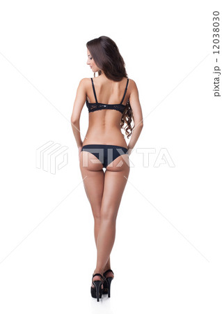 Rear view of suntanned girl in black lingerie 12038030