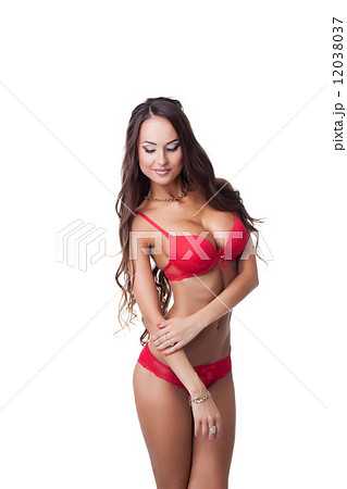 Flirtatious tanned model posing in red lingerie 12038037