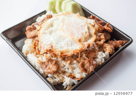Egg fried and fried pork garlic with soy sauce topped on rice Egg fried and fried pork garlic with soy sauce topped on rice 12056977