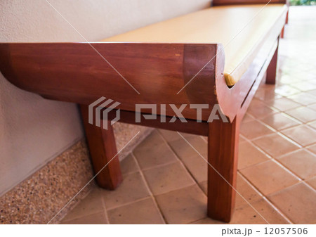 Unoccupied wooden bed chair in living room Unoccupied wooden bed chair in living room 12057506